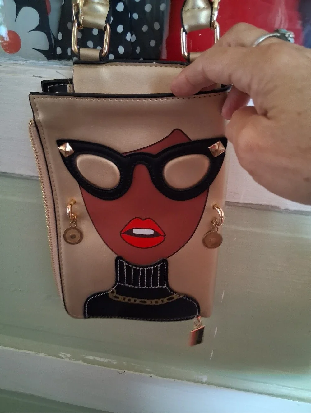Fashionable Gold Crossbody Bag with Graphic Face Design